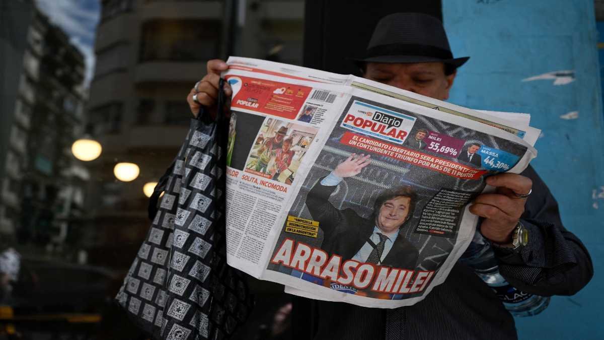 Un hombre lee un periódico este lunes, el día después de la victoria del partido La Libertad Avanza, del candidato Javier Milei en la elección presidencial en Argentina. Foto: Luis Robayo / AFP.