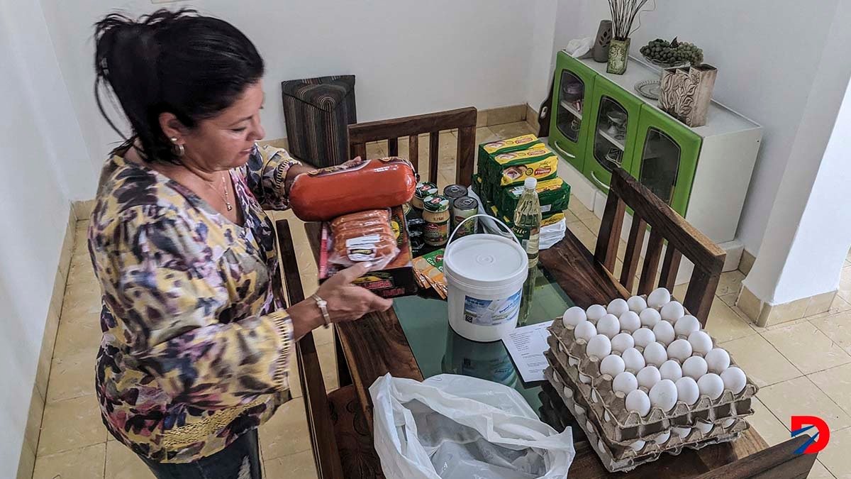 María Paez, una cubana de 59 años, organiza la comida que sus hijos le enviaron desde Miami, a través de una empresa de remesas. Foto: Stringer / AFP.